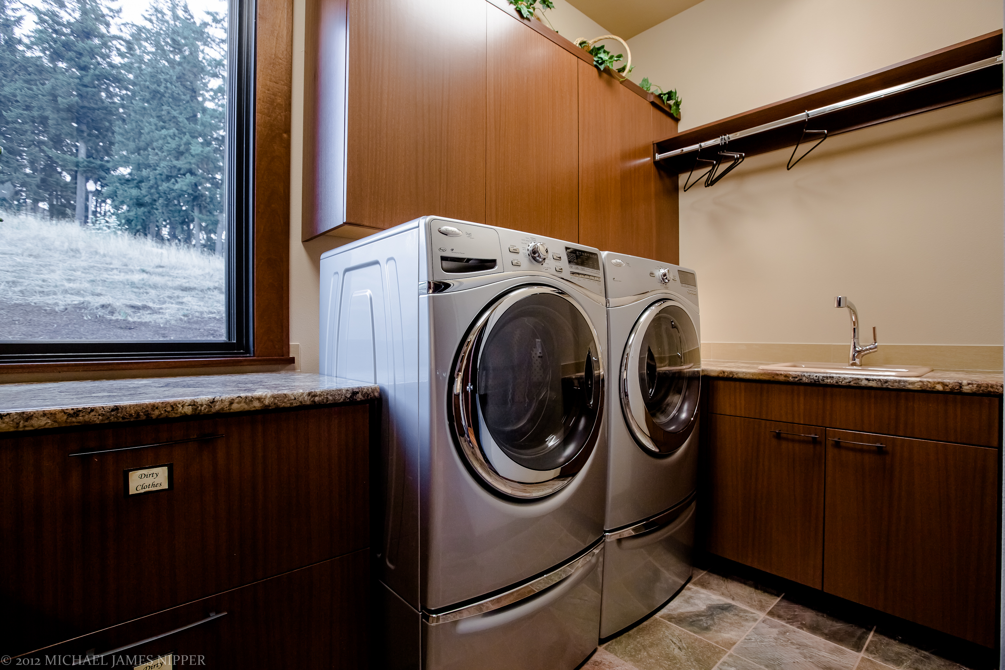 Laundry room with washer and dryer of 2013 Street of Dreams Custom Home 20-20 by Rick Bernard of Bernard Custom Homes.